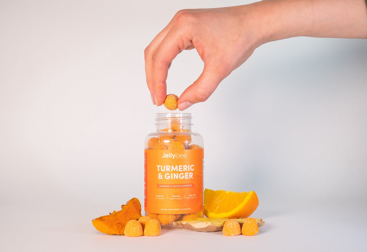 Women adding a pill into the bottle with turmeric and ginger supplements